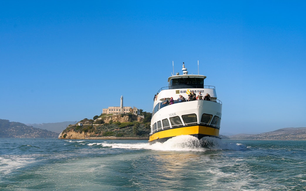 Ferry with guests sailing near Alcatraz Island, San Francisco.
