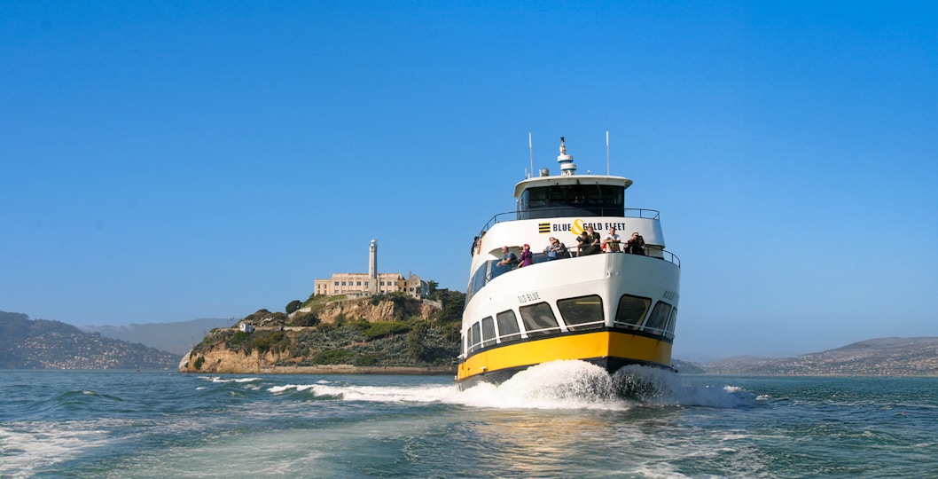 Ferry with guests sailing near Alcatraz Island, San Francisco.