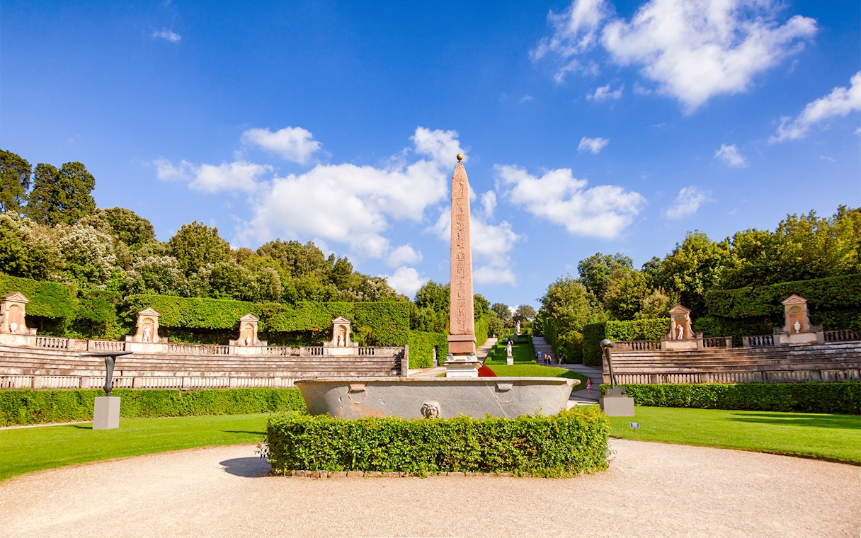 Amphitheater at Boboli Gardens with central obelisk and surrounding greenery in Florence, Italy.