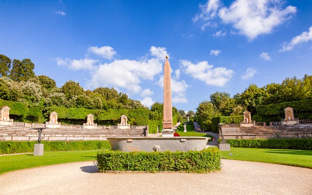 Amphitheater at Boboli Gardens with central obelisk and surrounding greenery in Florence, Italy.