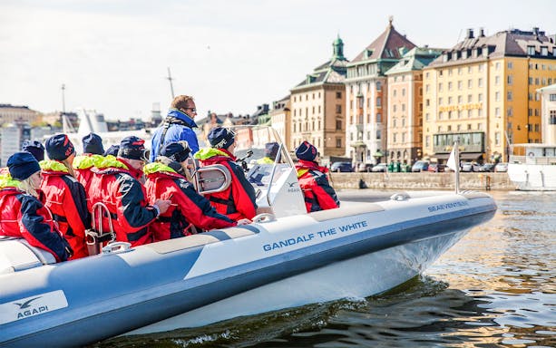 Passengers on the Stockholm RIB Speed Boat tour, cruising past Stockholm's waterfront landmarks.
