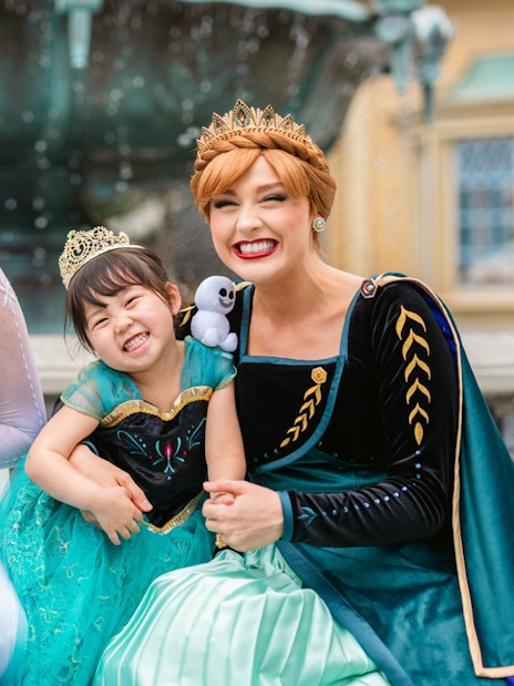 Girls dressed as Anna and Elsa with characters at Frozen Ever After, Disneyland Hong Kong.