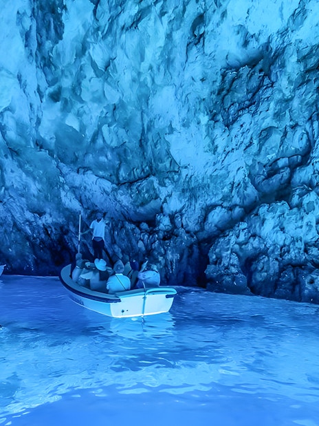 Visitors in a small boat explore the Blue Cave near Split.