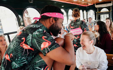 Comedian interacting with a laughing passenger on the Nashville For Morons Comedy Trolley Tour.