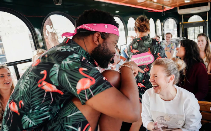 Comedian interacting with a laughing passenger on the Nashville For Morons Comedy Trolley Tour.