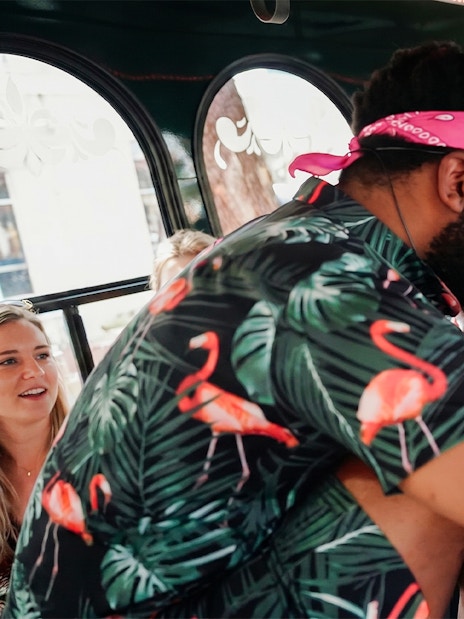 Comedian interacting with a laughing passenger on the Nashville For Morons Comedy Trolley Tour.