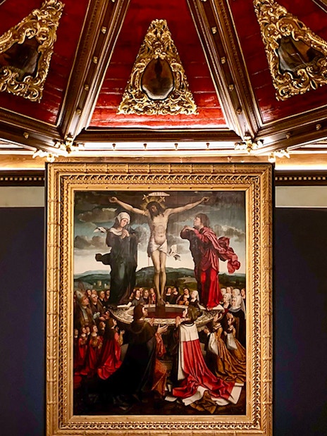 Crucifixion painting in Misericórdia Museum, Porto, with ornate ceiling detail.