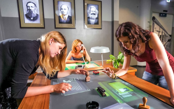 Visitors interacting with exhibits at DDR Museum Berlin.
