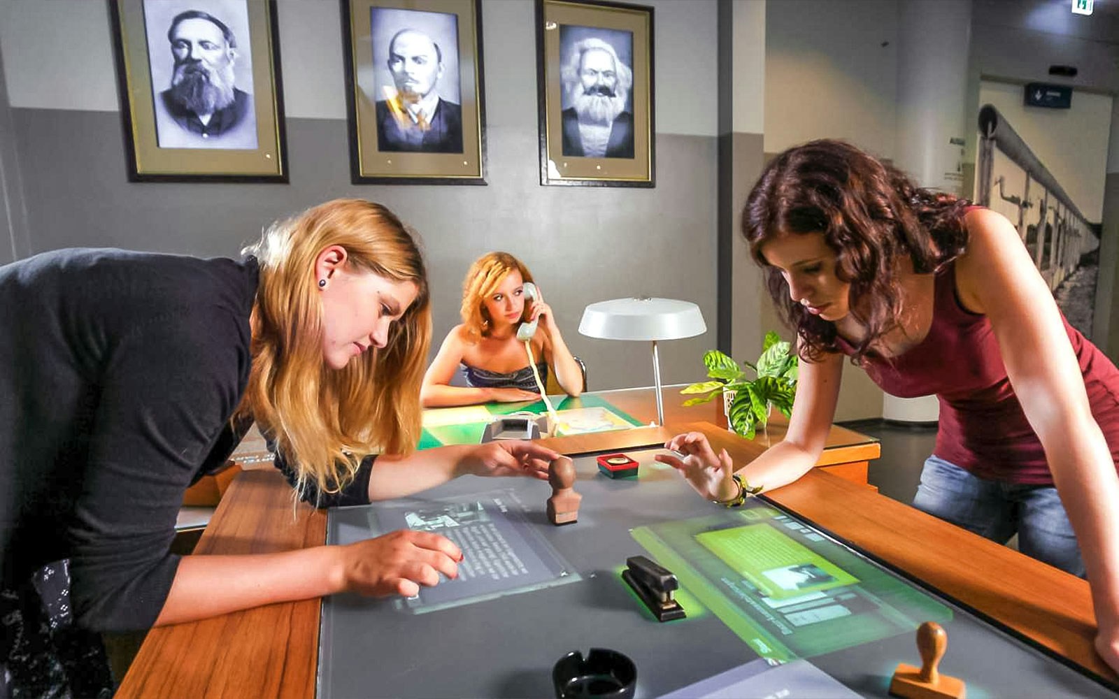 Visitors interacting with exhibits at DDR Museum Berlin.