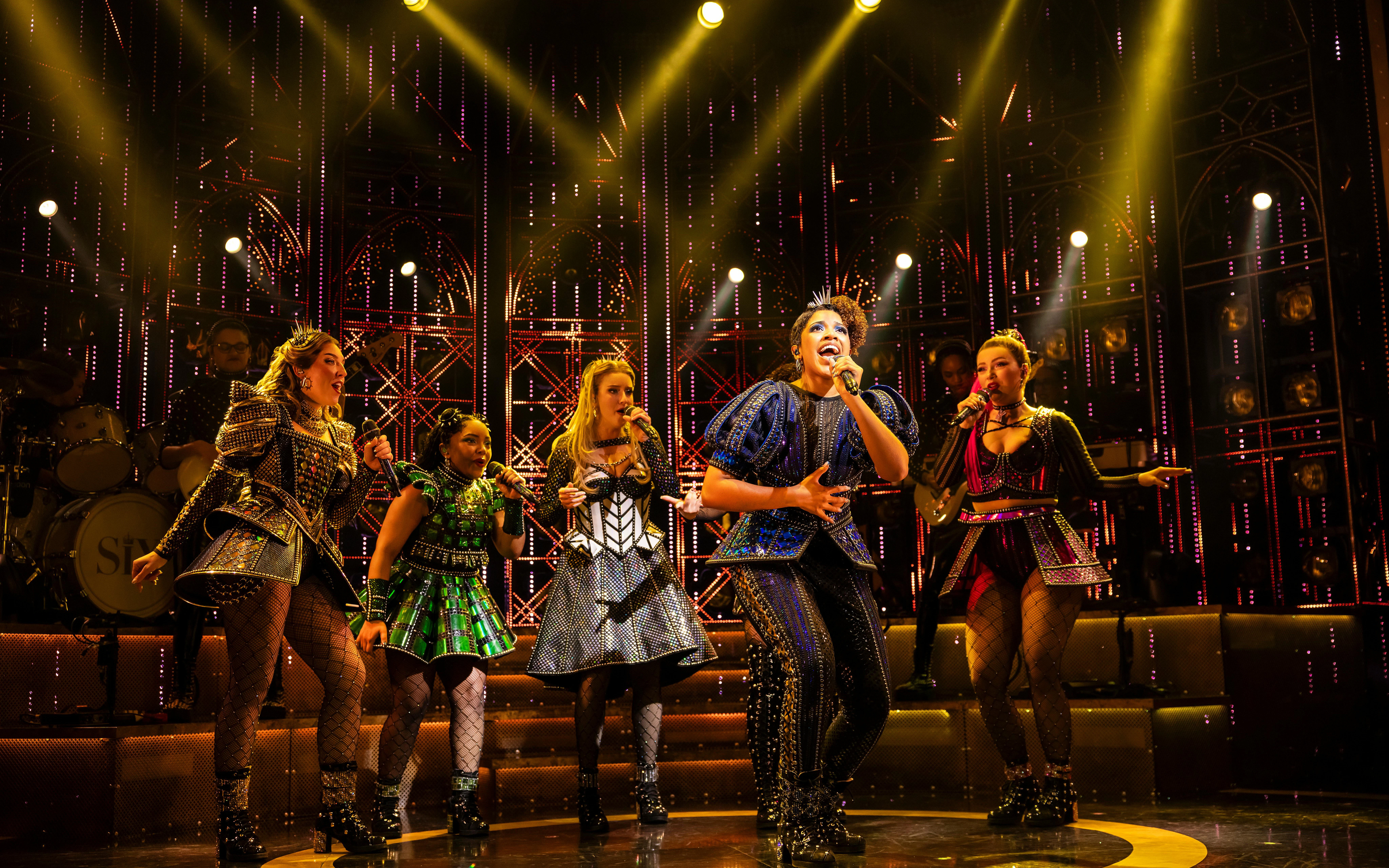 Performers singing on stage during Six musical in West End.