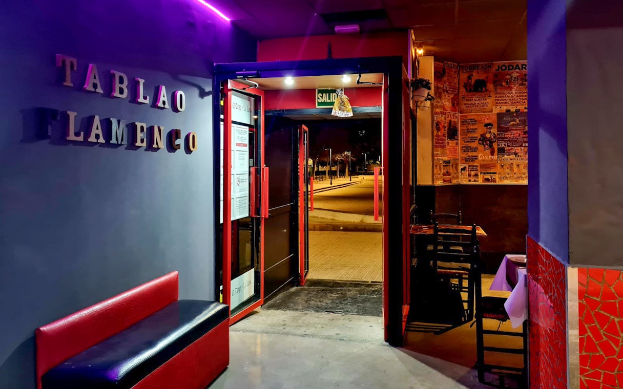 Entrance to Tablao El Toro y la Luna, showcasing flamenco posters and seating area.