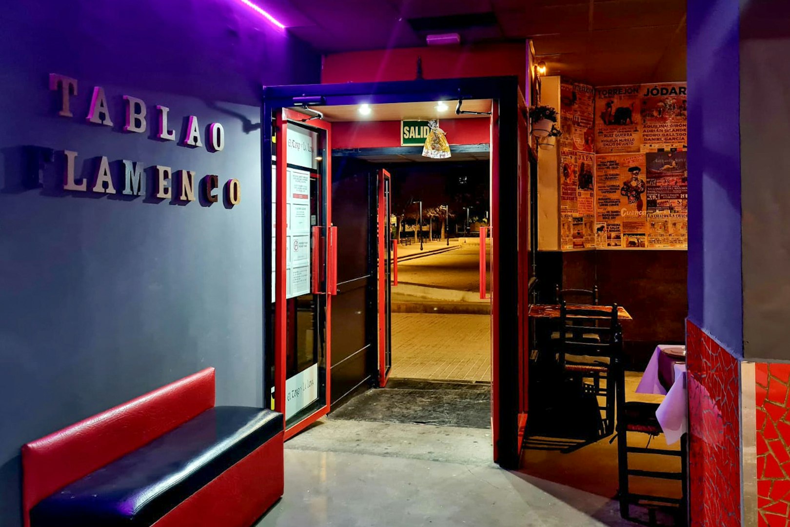 Entrance to Tablao El Toro y la Luna, showcasing flamenco posters and seating area.