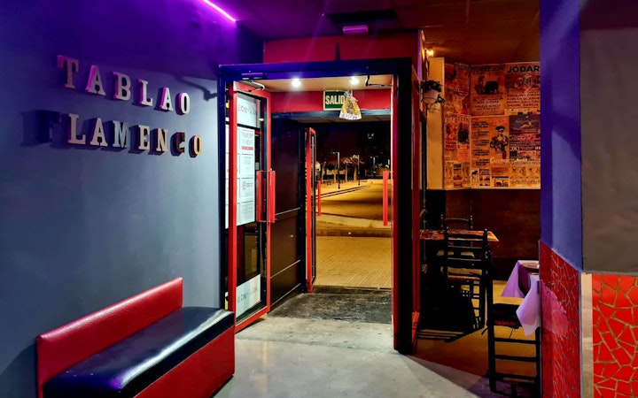 Entrance to Tablao El Toro y la Luna, showcasing flamenco posters and seating area.