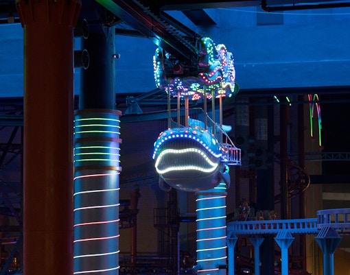 Cable cars ascending over lush Genting Highlands, Malaysia, offering panoramic views.