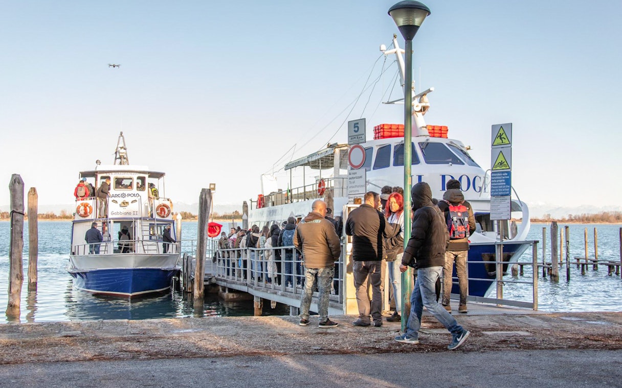 Passengers boarding a ferry at the Venice port.