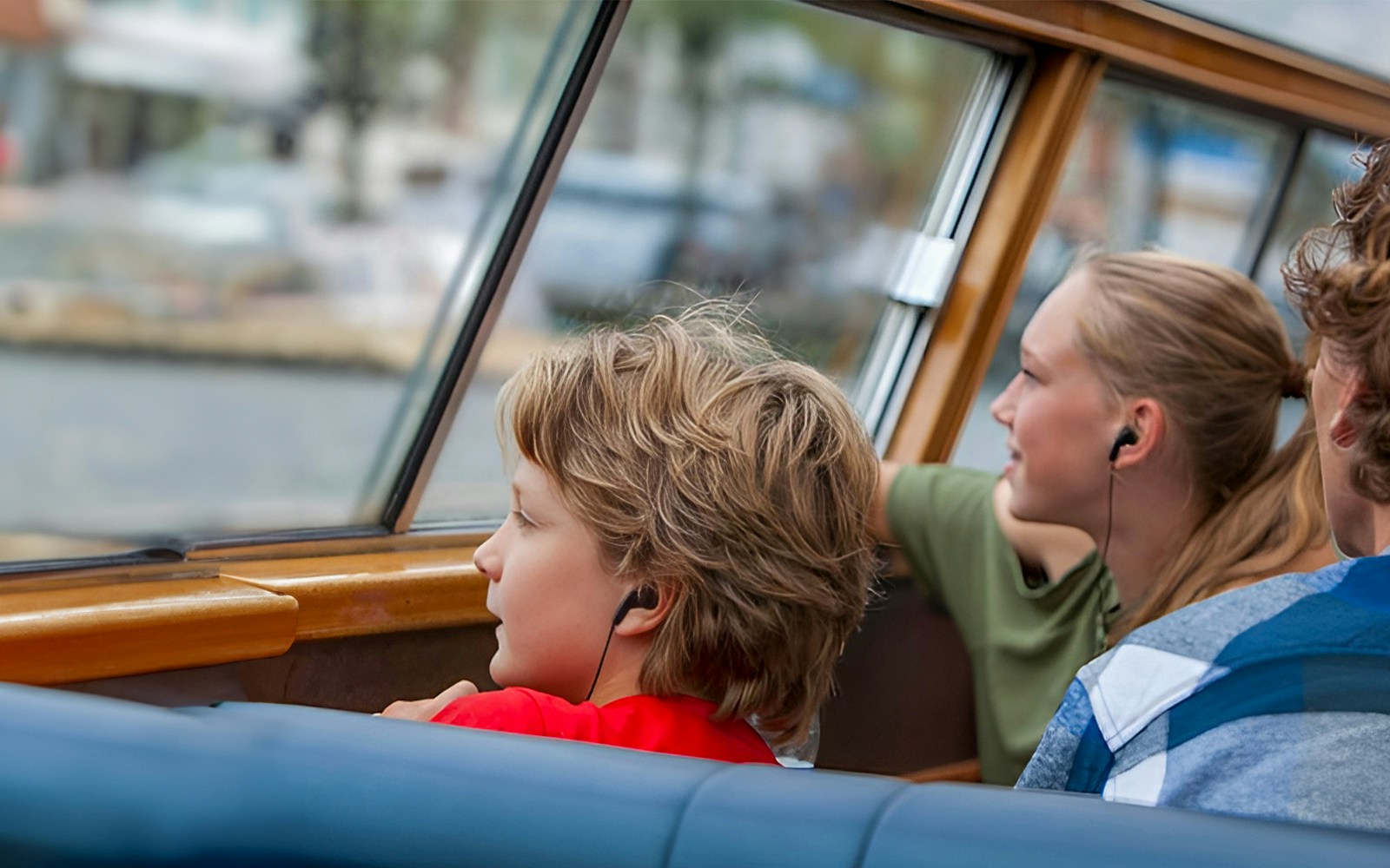 Passengers using audio guides on a canal cruise.