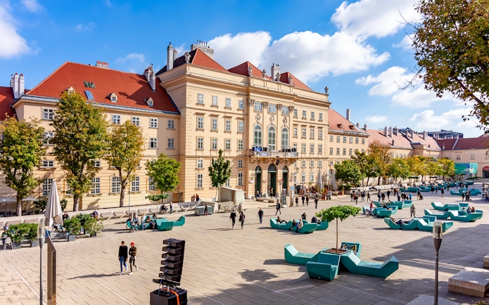 Courtyard of MuseumsQuartier Vienna with people and modern seating.