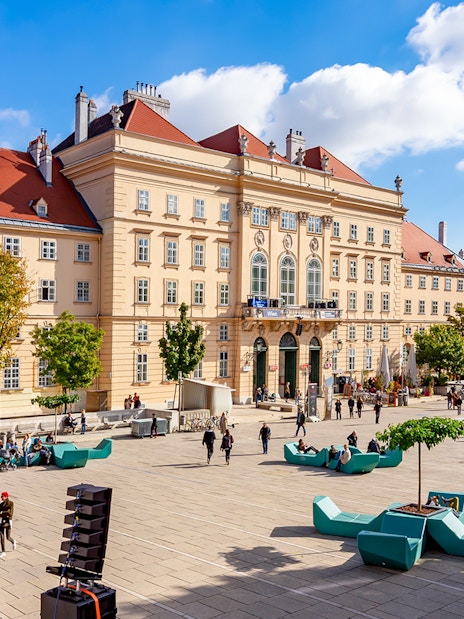 Courtyard of MuseumsQuartier Vienna with people and modern seating.