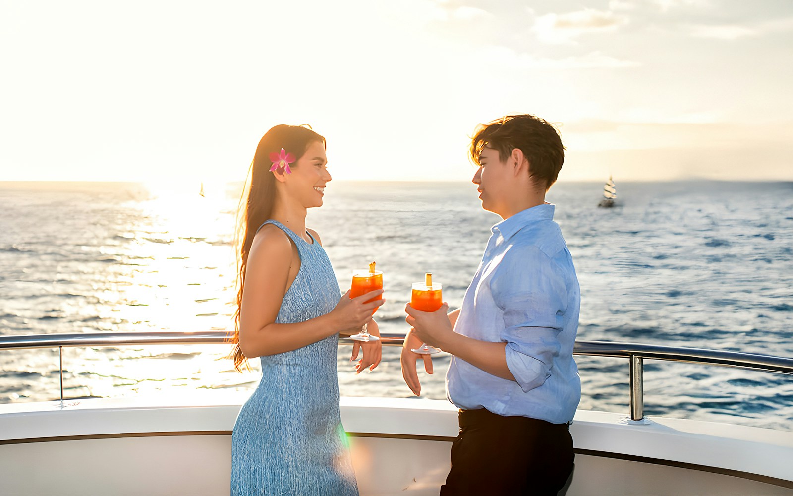 Couple enjoying Mai Tai on a sunset cruise in Waikiki, Hawaii.