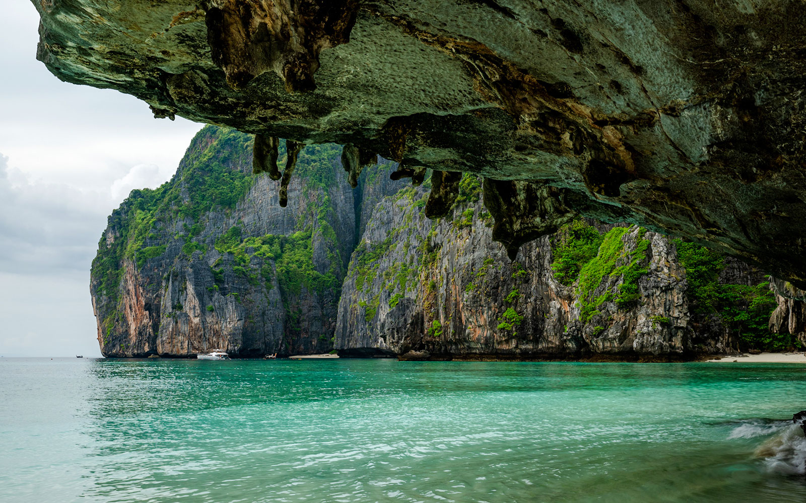 View from a sea cave of Maya Bay's limestone cliffs and clear water, Phi Phi Island.