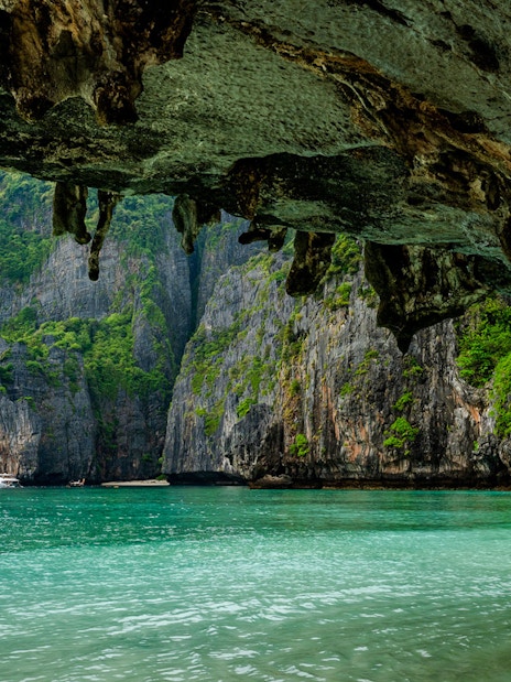 View from a sea cave of Maya Bay's limestone cliffs and clear water, Phi Phi Island.