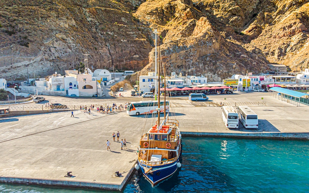 Bus and boat at Santorini port for tourist transfers.