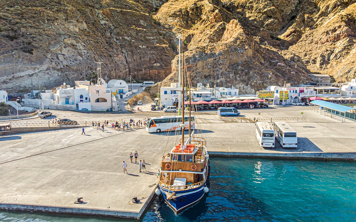 Bus and boat at Santorini port for tourist transfers.