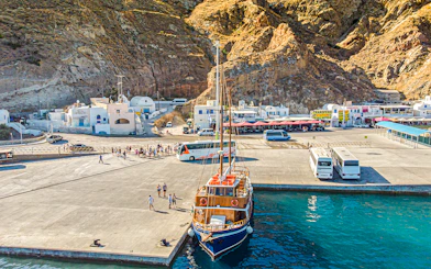 Bus and boat at Santorini port for tourist transfers.