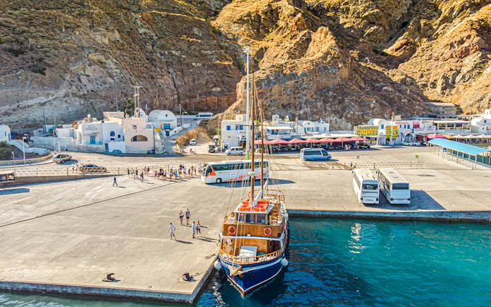 Bus and boat at Santorini port for tourist transfers.
