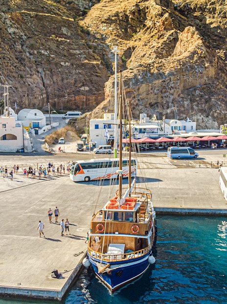 Bus and boat at Santorini port for tourist transfers.