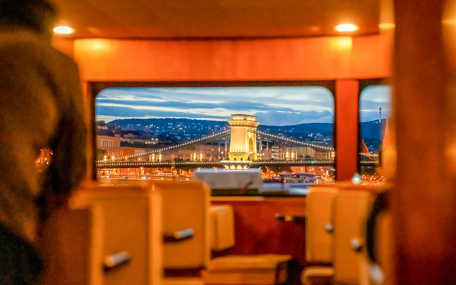 Budapest Danube River nighttime cruise with illuminated Parliament building in view.