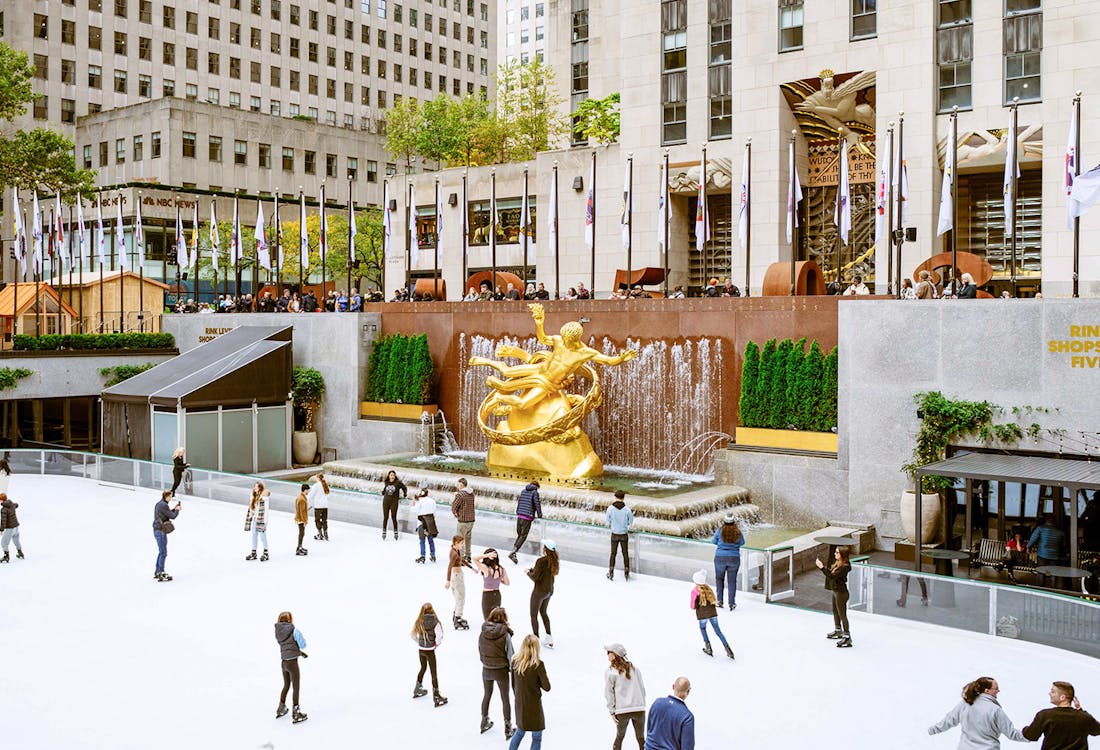 Rockefeller Center ice skating rink with skaters in New York City.
