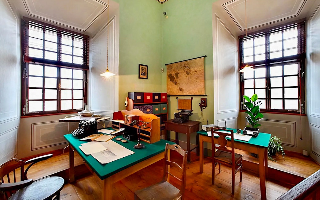 Cesky Krumlov Castle interior office with vintage typewriter and map.