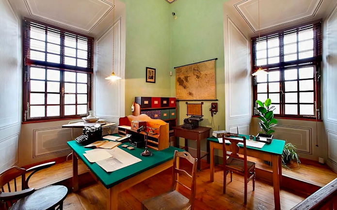 Cesky Krumlov Castle interior office with vintage typewriter and map.