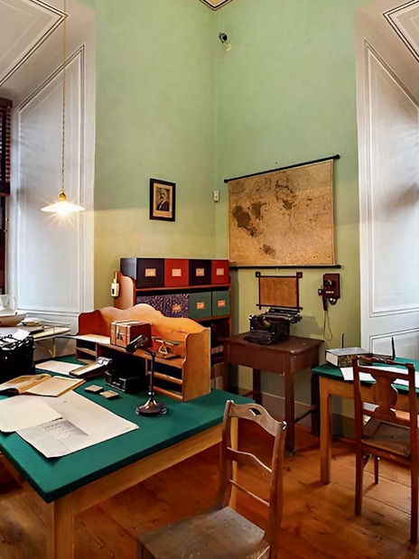 Cesky Krumlov Castle interior office with vintage typewriter and map.