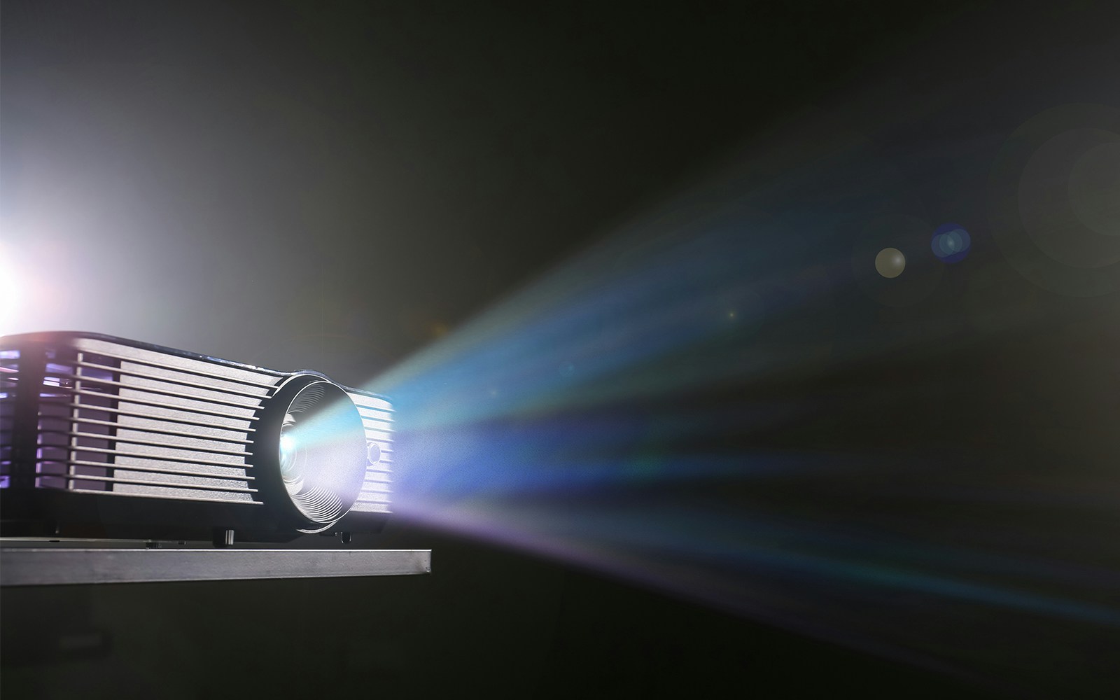 Projector casting light onto a surface, enhancing visual presentations in a travel tour setting.