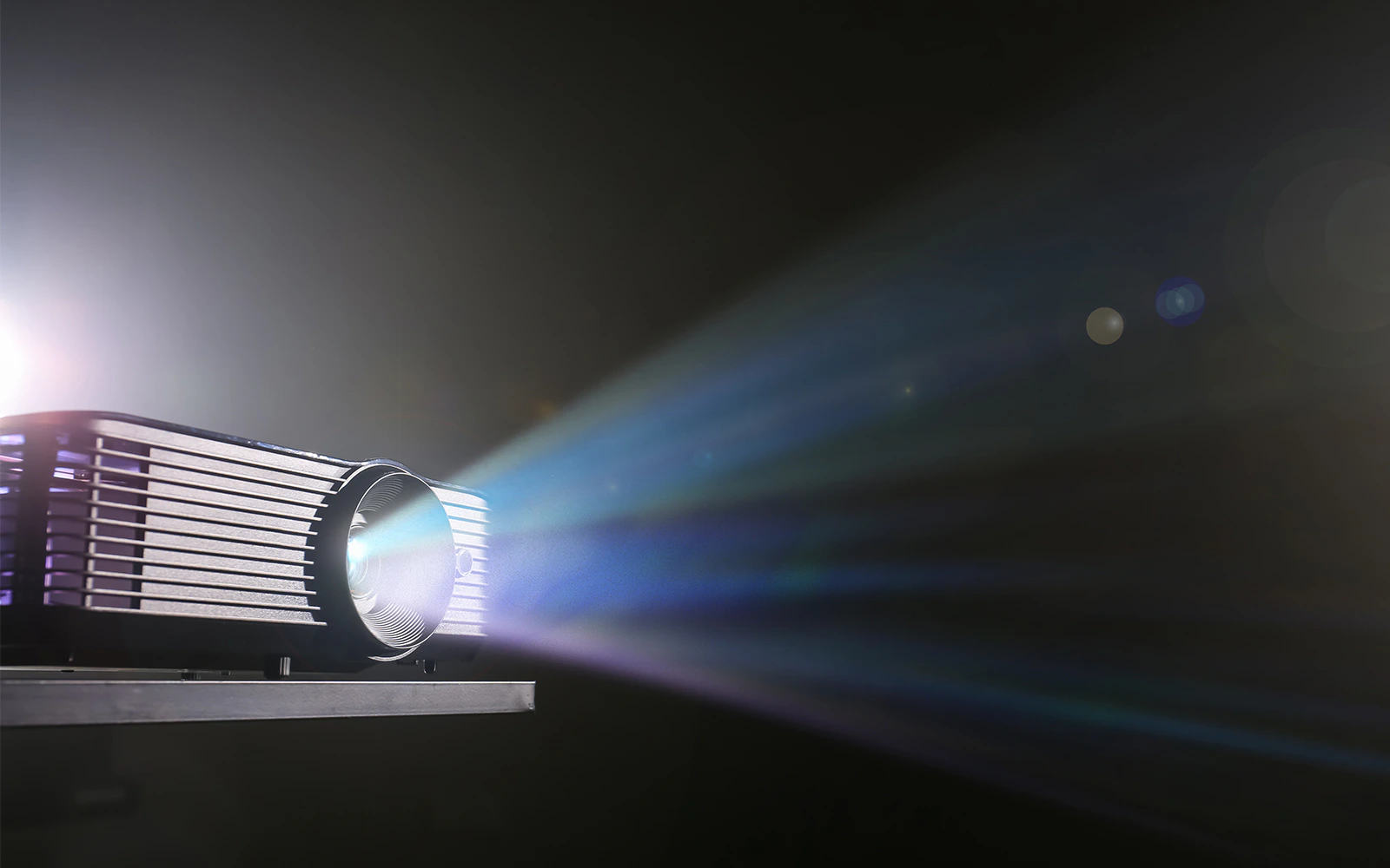 Projector casting light onto a surface, enhancing visual presentations in a travel tour setting.