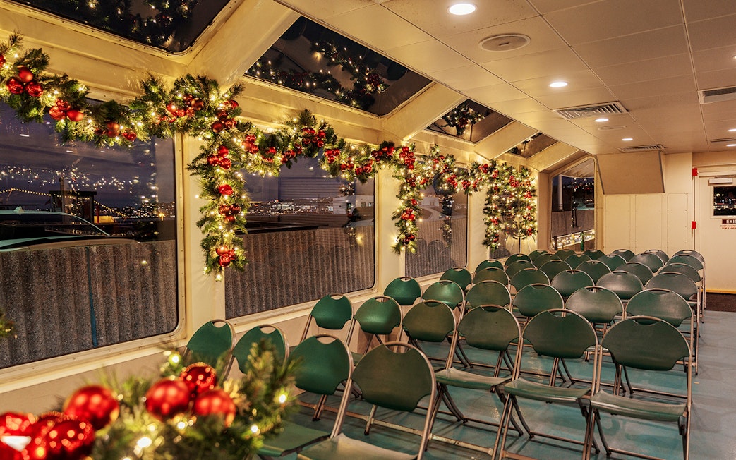 Interior of a festively decorated boat with garlands and lights, Circle Line Harbor Lights Cruise.