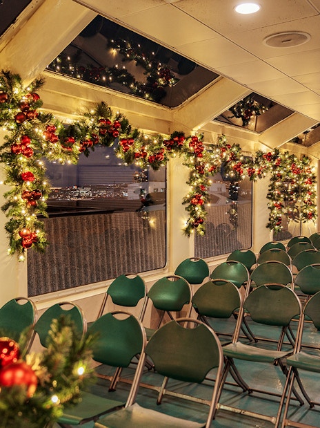 Interior of a festively decorated boat with garlands and lights, Circle Line Harbor Lights Cruise.