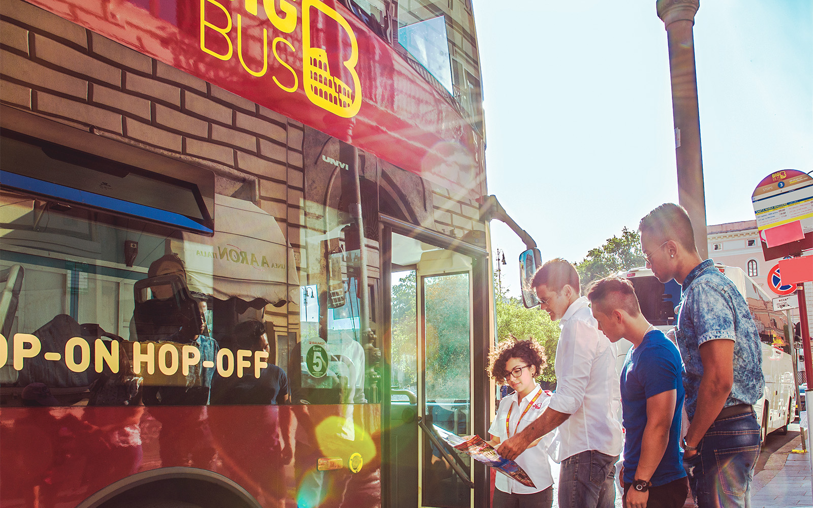 Tourists boarding a hop-on hop-off bus for Rome city sightseeing.