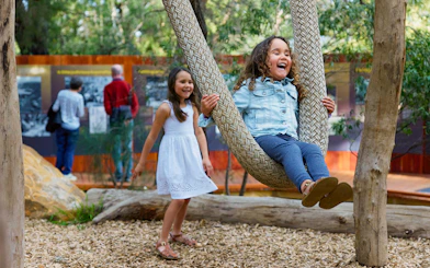 Children playing on a rope swing at Ngilgi Cave Ancient Lands Experience.