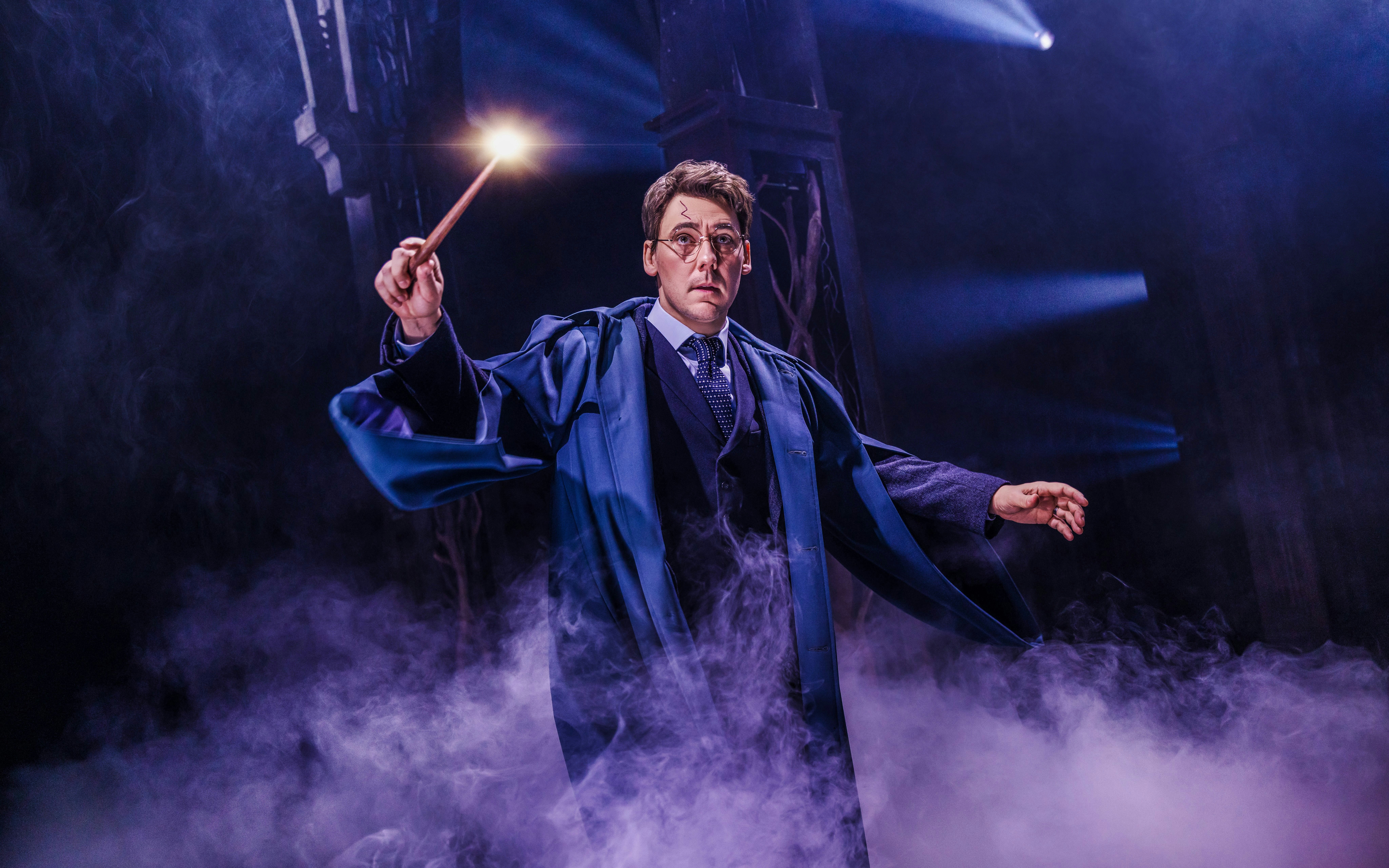 Actor performing magic scene in "Harry Potter and the Cursed Child" on Broadway stage.