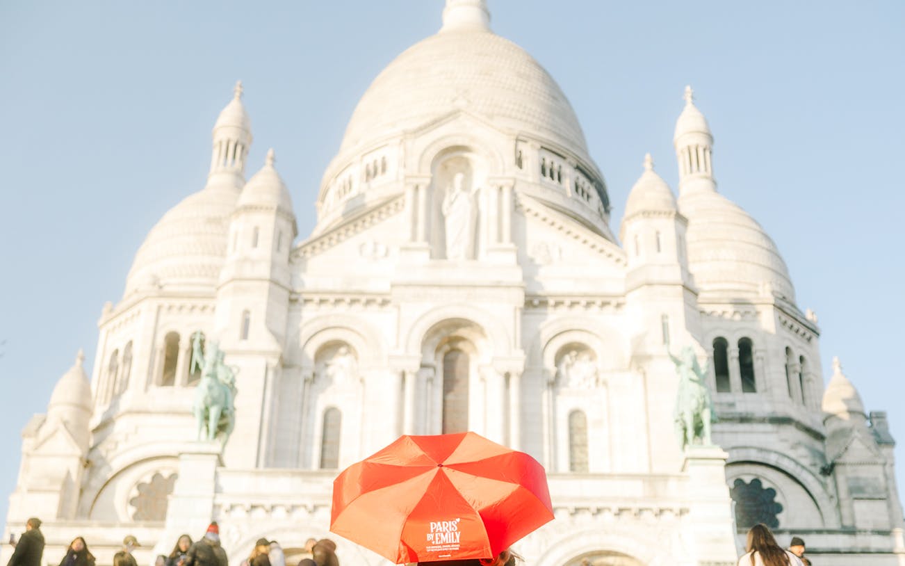 Sacre-Coeur Basilica with red umbrella, Montmartre Walking Tour, Paris.