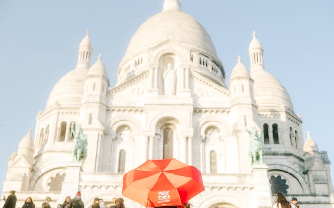 Sacre-Coeur Basilica with red umbrella, Montmartre Walking Tour, Paris.