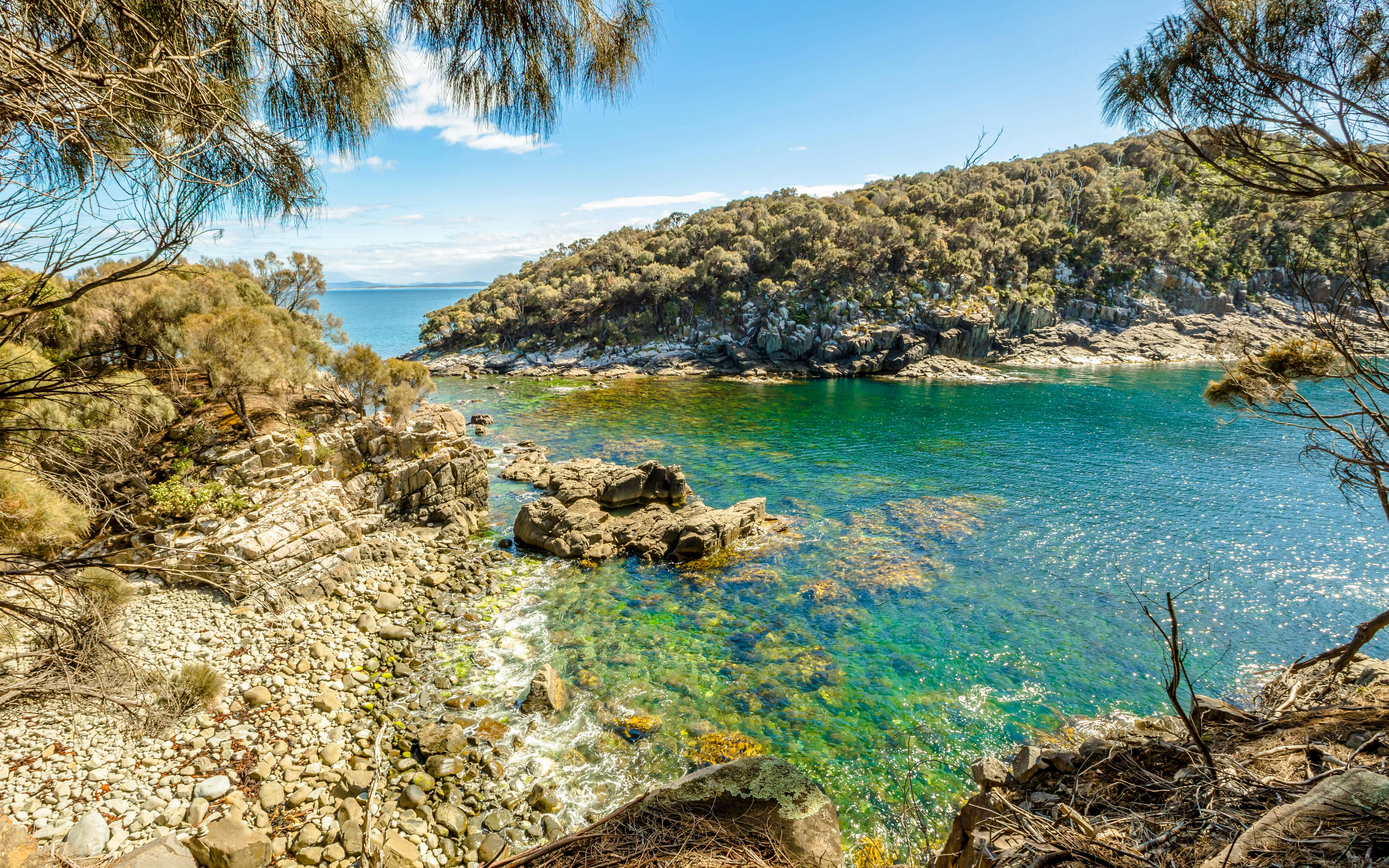 Rocky coastline and clear blue waters at Bruny Island, Tasmania.