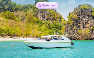 Speedboat near limestone cliffs at Hong Island, Thailand.
