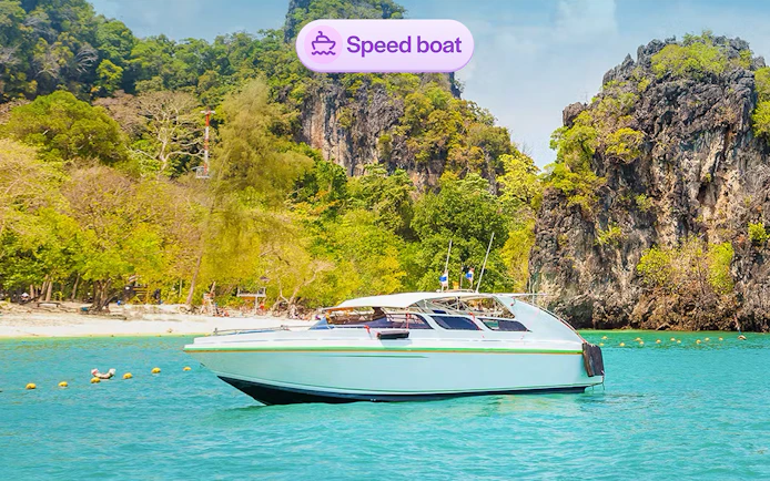 Speedboat near limestone cliffs at Hong Island, Thailand.