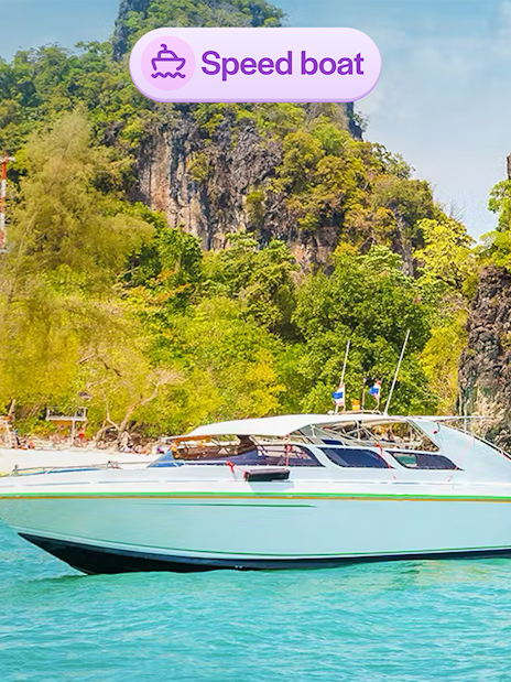 Speedboat near limestone cliffs at Hong Island, Thailand.
