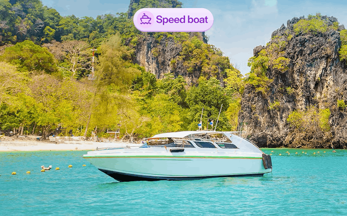 Speedboat near limestone cliffs at Hong Island, Thailand.