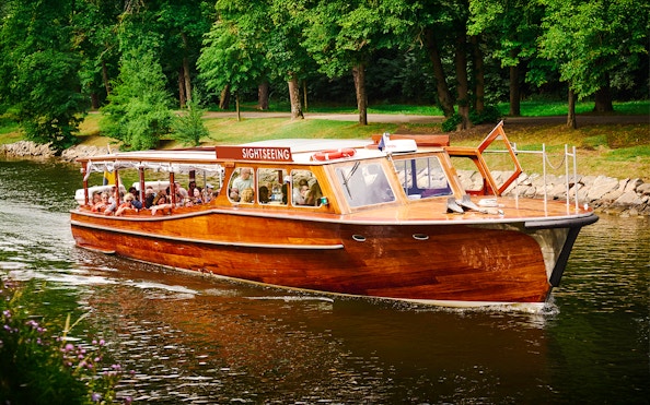 Classic wooden sightseeing boat cruising Stockholm Archipelago.